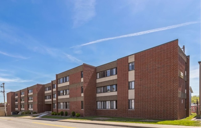 an apartment building on a street with a blue sky