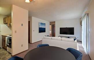 a living room with a couch and a table. Fargo, ND Pacific South Apartments