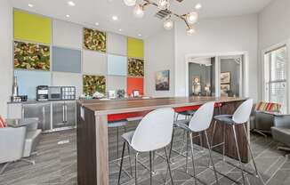 A modern kitchen with a dining table and chairs.