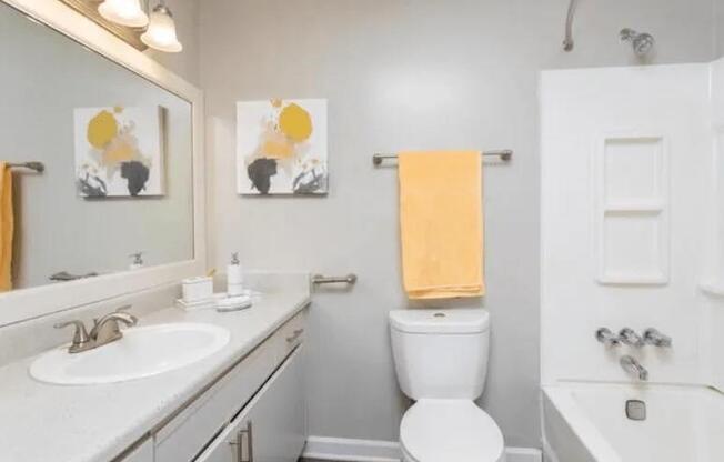 a bathroom with a toilet and a sink and a mirror at The Sapphire, Georgia