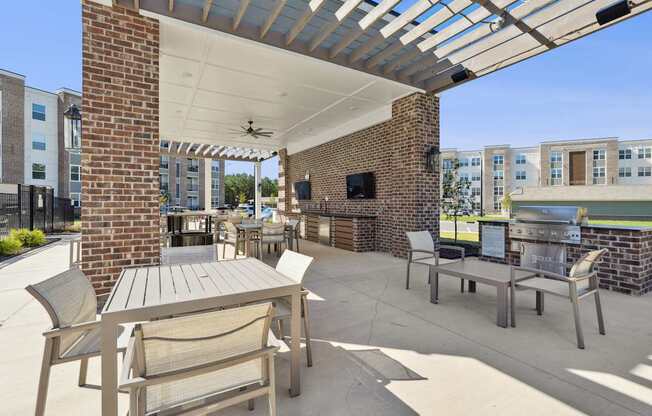A patio with a table and chairs under a roof.