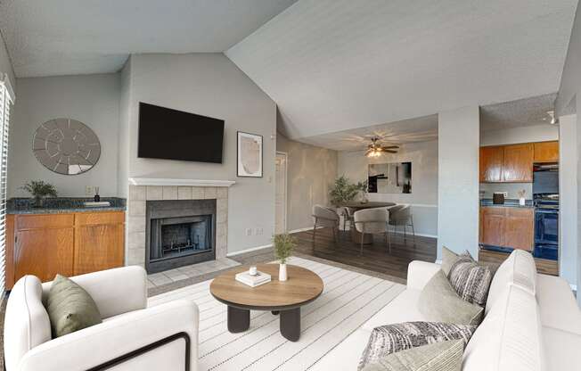 A living room with a fireplace and a television.