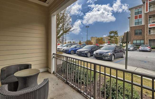 a patio with chairs and cars parked in a parking lot at Nexus at Sandhill, Columbia, 29229
