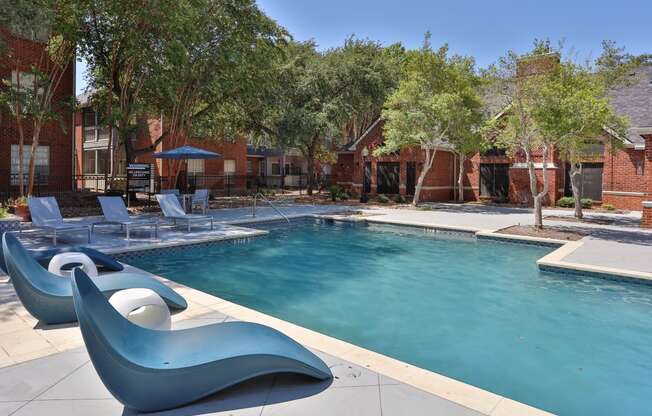 this is a photo of the pool area at harvard square apartments in dallas, tx