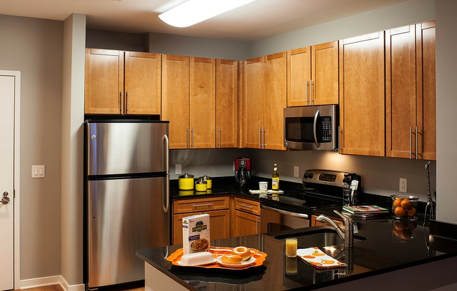 Contemporary Kitchen With Granite Countertops, Wood Cabinets & Stainless Steel Appliances