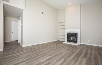 a living room with a fireplace and a bookshelf