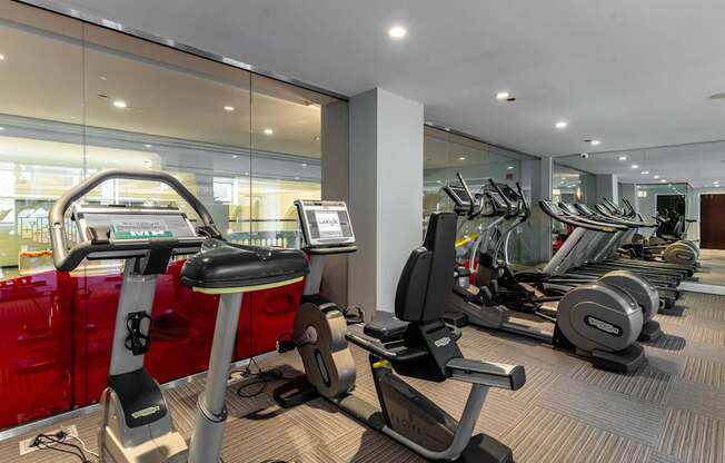a gym with cardio machines and weights on the floor