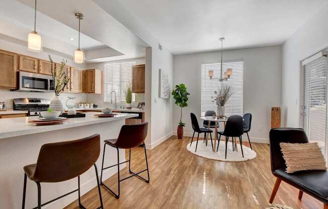A kitchen with a table and chairs.