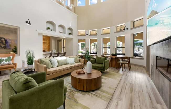 a living room with couches and chairs and a table