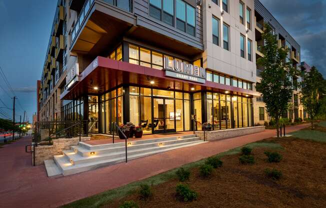 the building in which the hotel is located is lit up at night