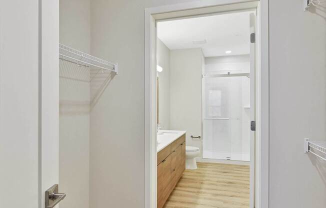 A white door is open to a bathroom.