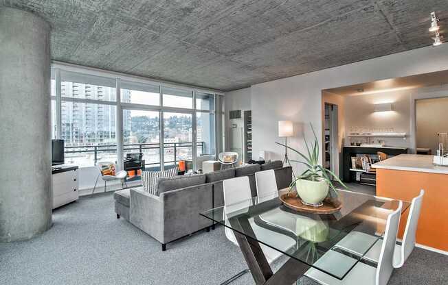 a living room with a glass table and a couch