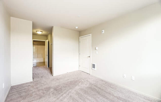 A room with a carpeted floor and white walls.
