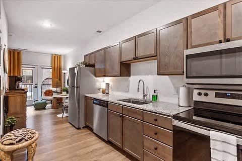 a kitchen with stainless steel appliances and wooden cabinets