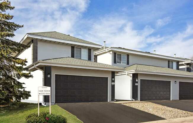 Burnsville, MN Townhomes – Summit Townhomes - house with a garage door and a sign in front of it