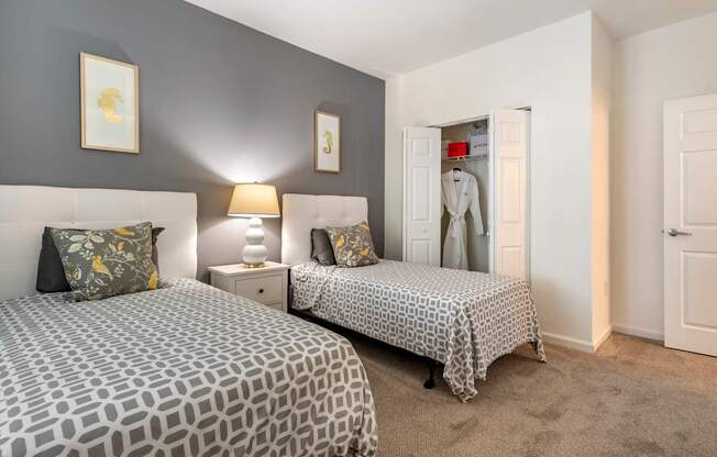 a bedroom with two beds and a closet at Pier Village Apartments, Long Branch, 07740