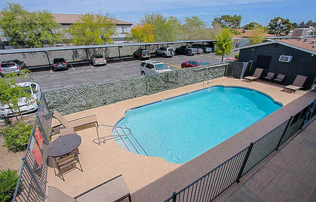 A small pool with a table and chairs.