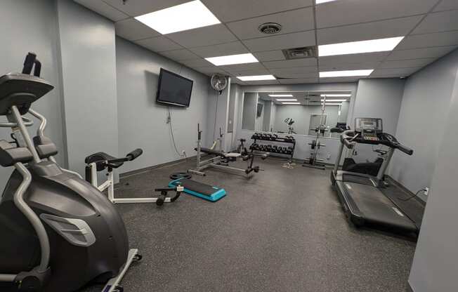 a gym with various exercise equipment in a building