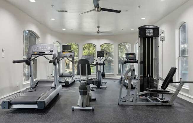 A spacious gym with treadmills, elliptical machines, and other exercise equipment.