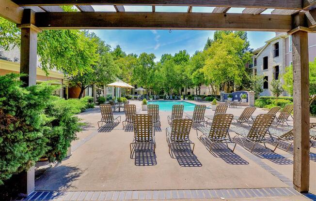 Resort pool chairs at  Bentley Place at Willow Bend Apartments in West Plano, TX, For Rent. Now leasing 1, 2, and 3 bedroom apartments.