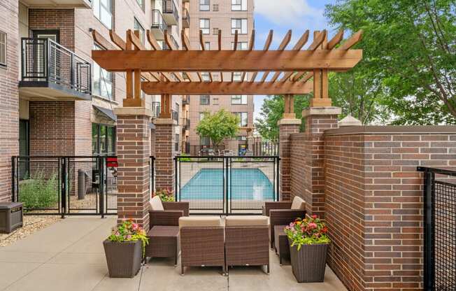 our apartments have a large patio with furniture and a pool