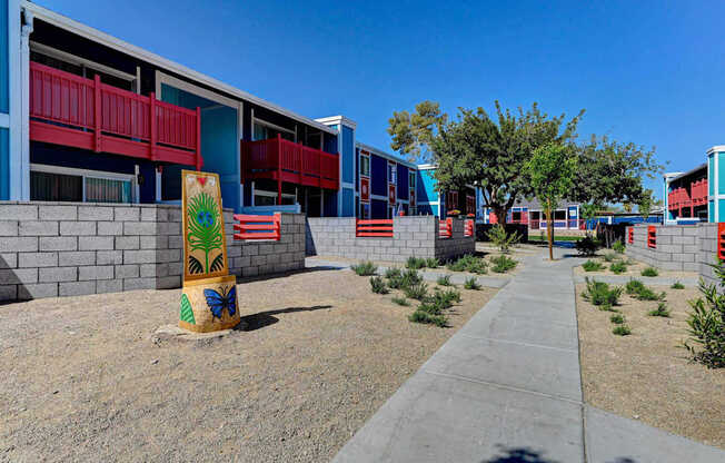 A colorful building with a red balcony and a yellow sign with a palm tree on it.