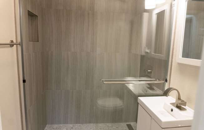 a small bathroom with a shower and a sink