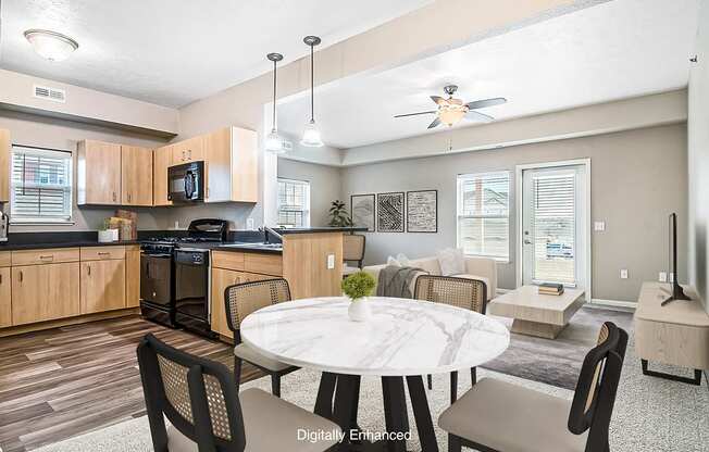 A kitchen with a window, and living room with a ceiling fan at Lynbrook Apartments and Townhomes, Elkhorn, NE, 68022