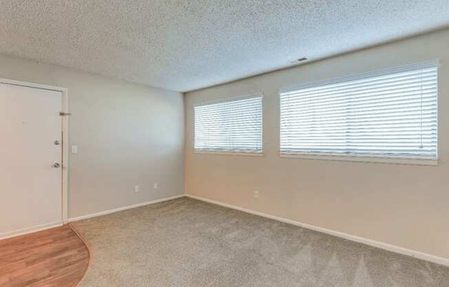 bedroom with windows at The Club at Cherry Hills Apartments