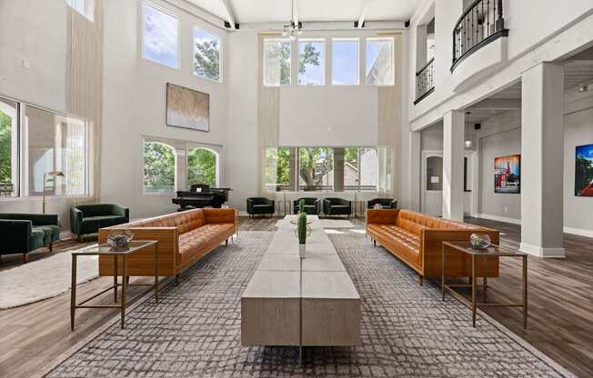 A spacious living room with a long wooden table in the center and multiple seating options.