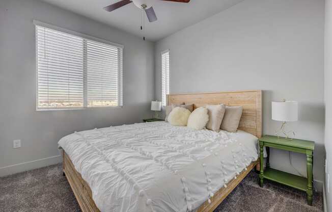 a bedroom with a large bed and a ceiling fan