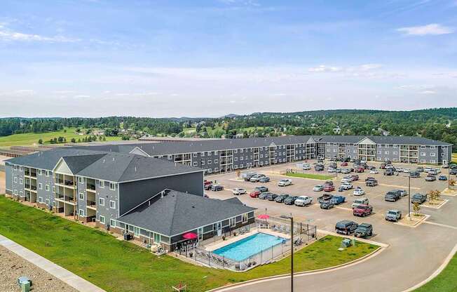 A large building with a pool in the middle of a parking lot.