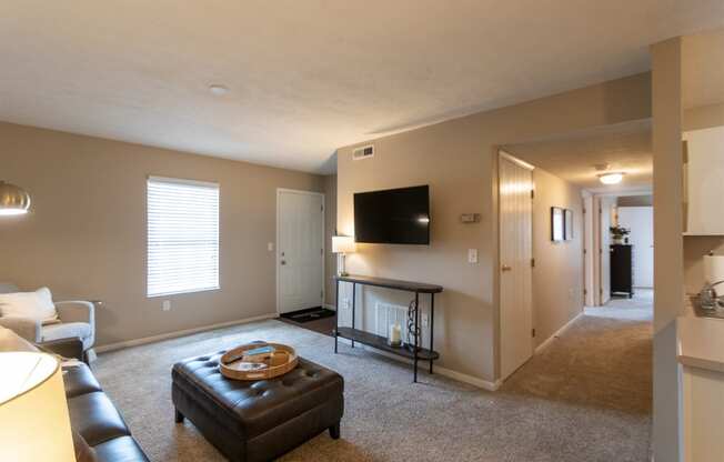 This is a photo of the living room and hallway of the 890 square foot 2 bedroom, 2 bath Liberty at Washington Place Apartments in in Miamisburg, Ohio in Washington Township.