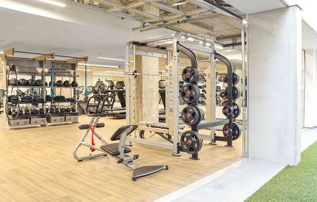 a spacious fitness room with a lot of exercise equipment