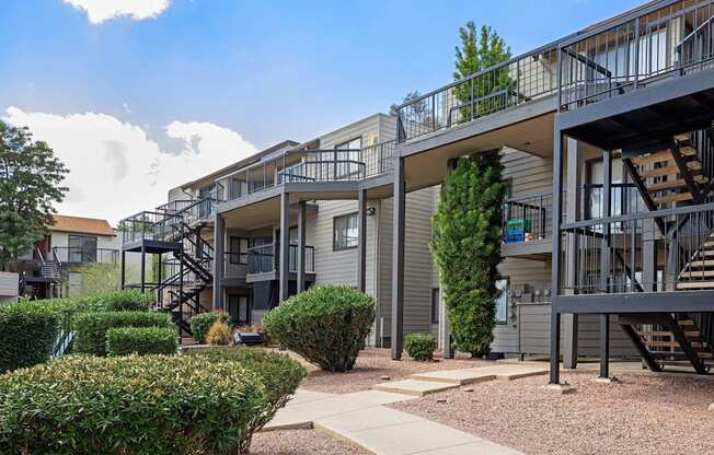 Apartment complex with a walkway between the buildings.
