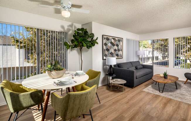 A living room with a dining table and chairs.