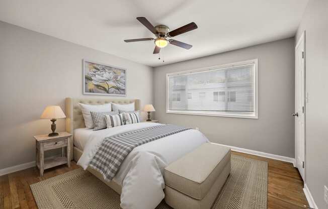 a bedroom with a large bed and a ceiling fan