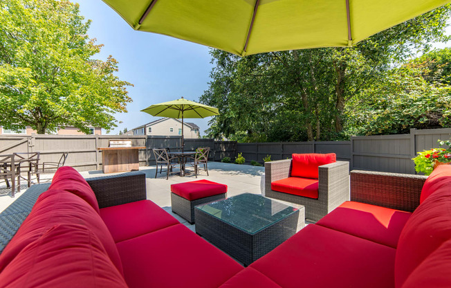 a patio with couches and chairs and a table at Quartz Creek, Mountlake Terrace