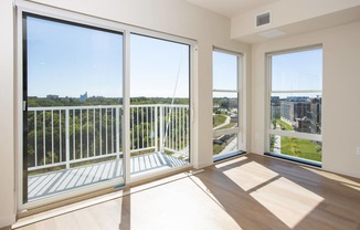 a living room with large windows and a view of the city at Riverhouse Apartments, Fargo, ND