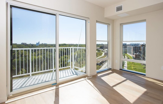 a living room with large windows and a view of the city at Riverhouse Apartments, Fargo, ND