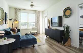 a living room with a blue couch and a tv