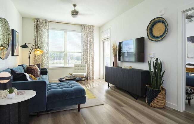 a living room with a blue couch and a tv