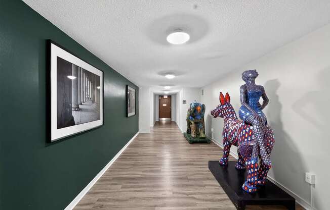 A hallway with a green wall and a framed black and white photo on the wall.