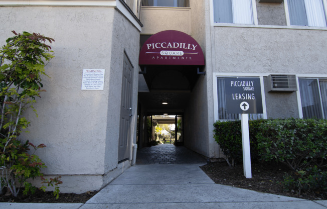 A building with a sign that says Piccadilly Apartments.