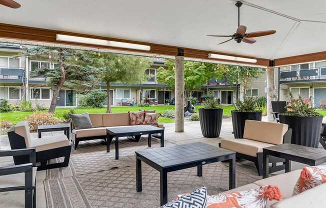 A patio with a table and chairs under a white canopy.