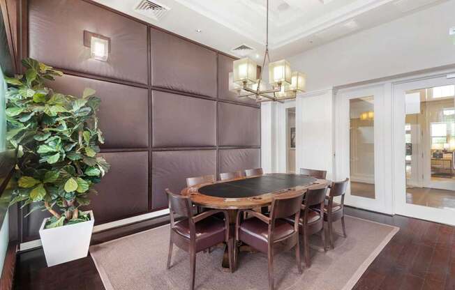 a dining room with a wooden table and chairs