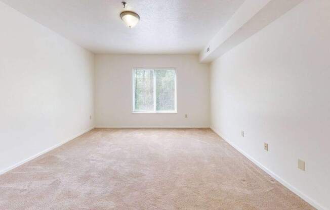 a spacious bedroom with a window at Fieldstream Apartment Homes, Iowa