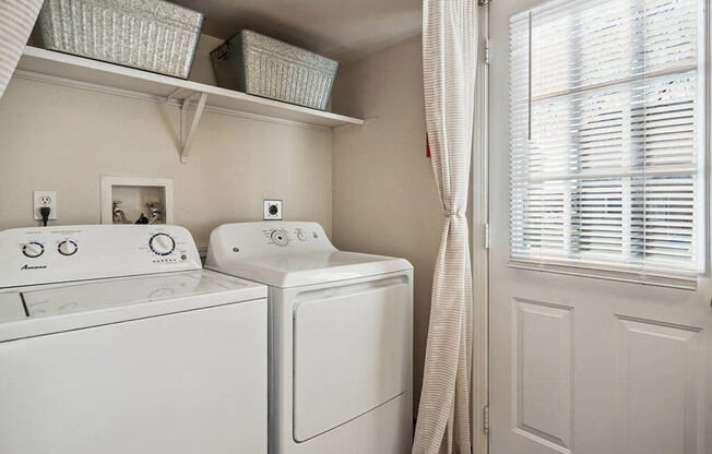 a washer and dryer in a laundry room with a window