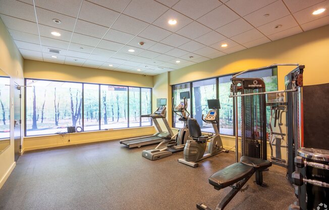 A gym with treadmills, exercise bikes, and weight machines at 603 Concord Apartments, Cambridge