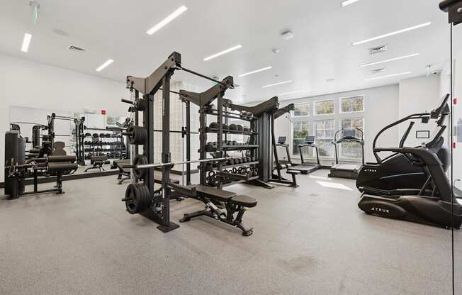 A gym with a variety of equipment including a leg press machine.